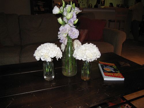 Carnations and ranunculus in milk jugs